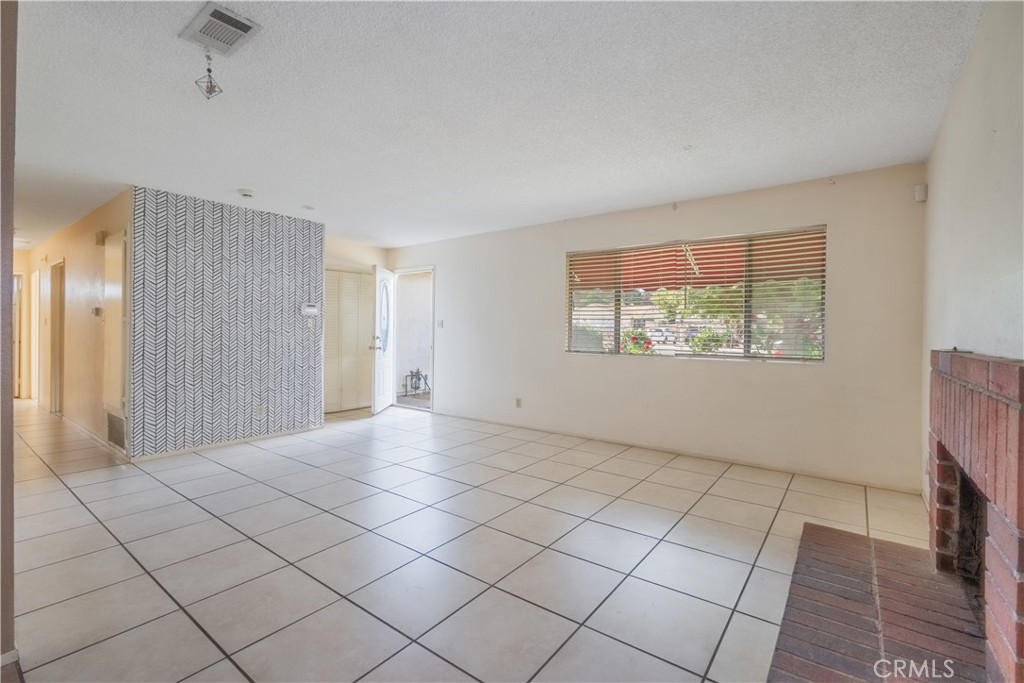 6084 Vanessa Street Riverside, CA 92504 - Photo 27 of 35 a view of an empty room with window and chandelier fan