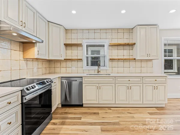 a view of a room with wooden floor and windows