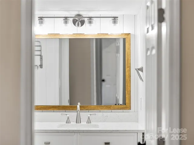 a spacious bathroom with a bathtub shower sink mirror and toilet