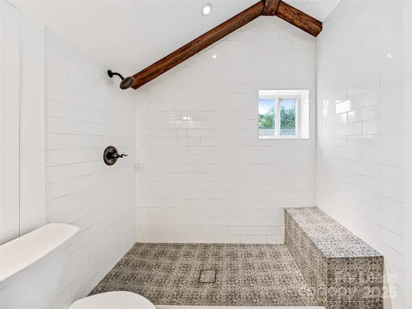 a bathroom with a toilet a sink a mirror a bathtub and vanity