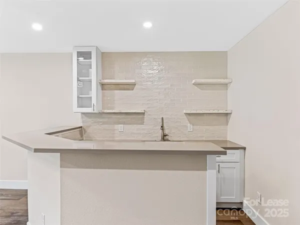 a view of kitchen with stainless steel appliances cabinets and wooden floor