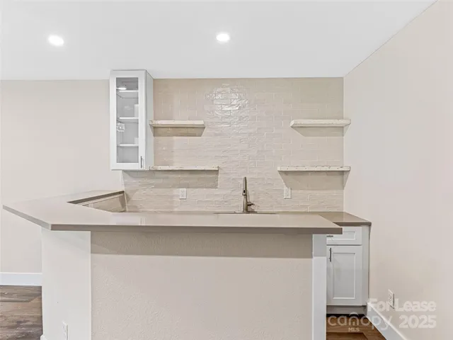 a view of kitchen with stainless steel appliances cabinets and wooden floor