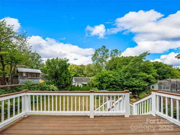 a view of balcony with wooden floor and fence