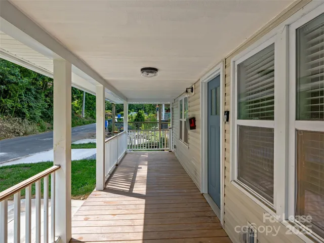a view of a porch with wooden floor and outdoor space