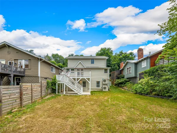 a view of a house with a yard balcony and sitting area