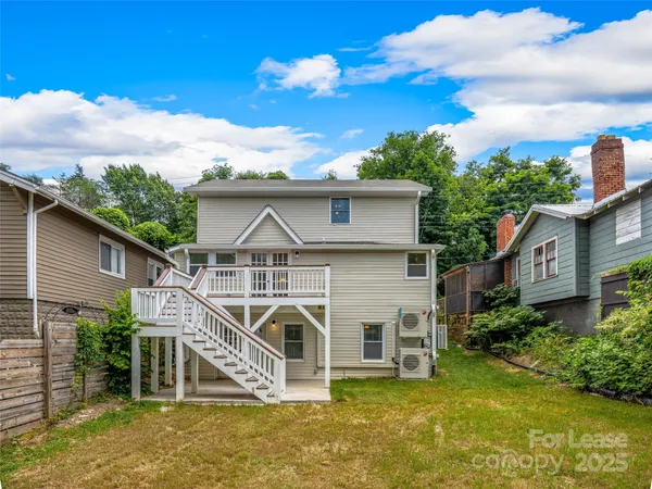 a view of a house with wooden fence