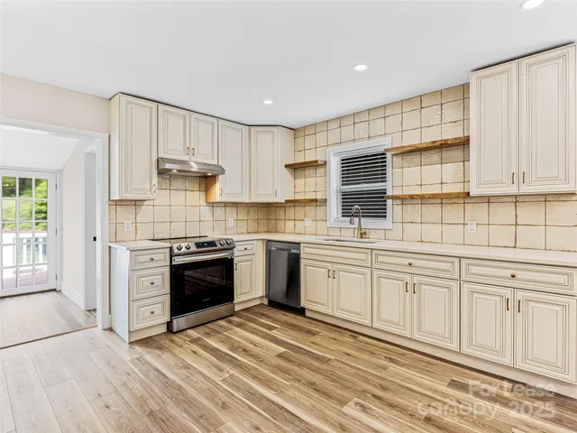 a kitchen with granite countertop a stove and a refrigerator