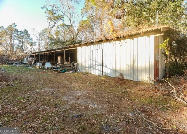 a backyard of a house with table and chairs