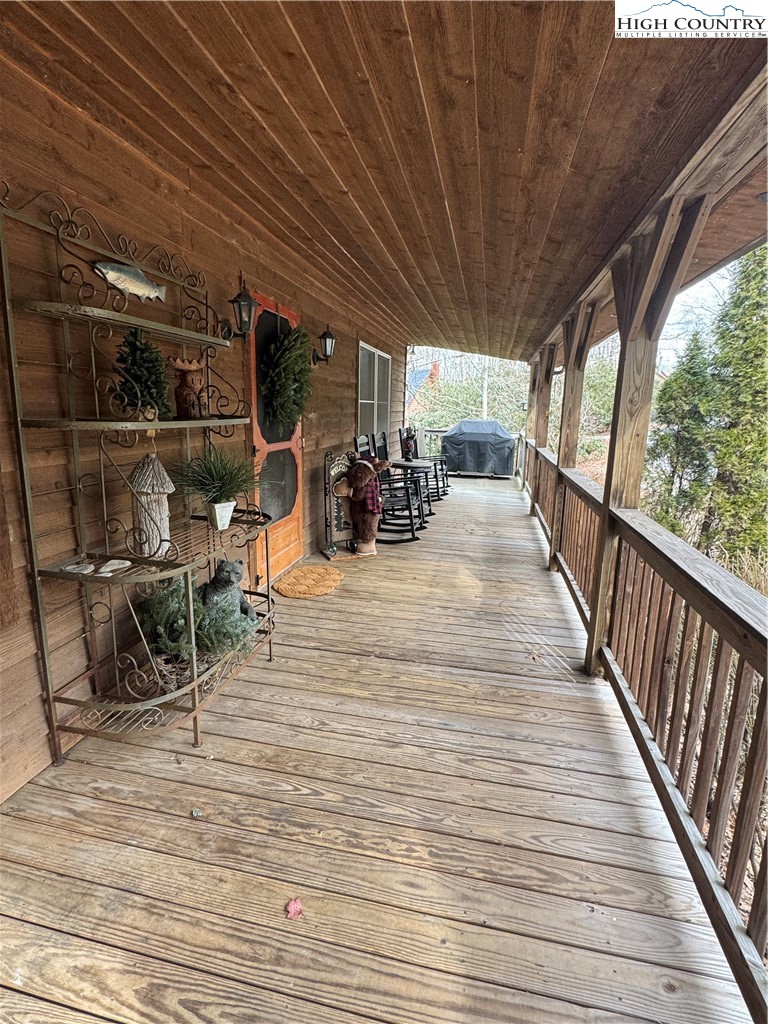 128 Hillcrest Road Newland, NC 28657 - Photo 31 of 37 a view of a patio with table and chairs with wooden floor and fence