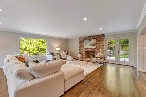 a bathroom with a sink a mirror and next to a window