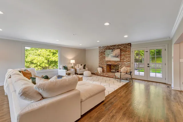 a bathroom with a sink a mirror and next to a window