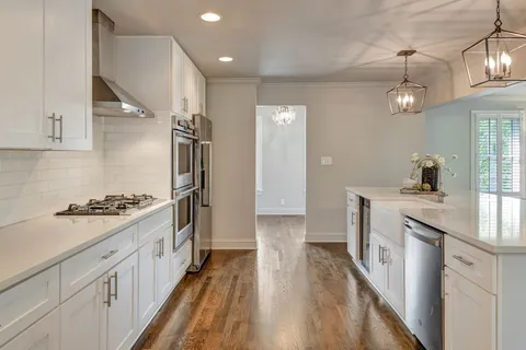 a view of a kitchen and dining room with wooden floor