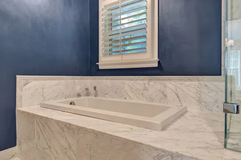 a view of a room with wooden floor and large windows