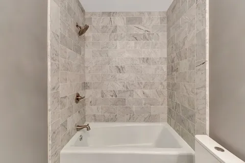 a view of a patio with table and chairs potted plants and large tree