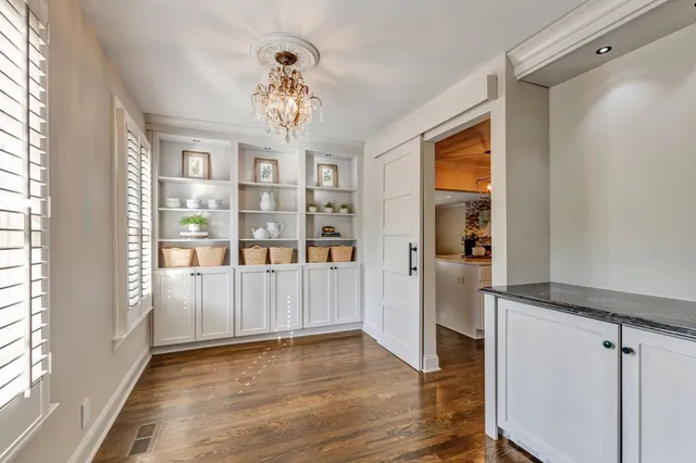 a view of a a dining room with furniture window and wooden floor