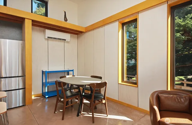 a dining room with furniture and window
