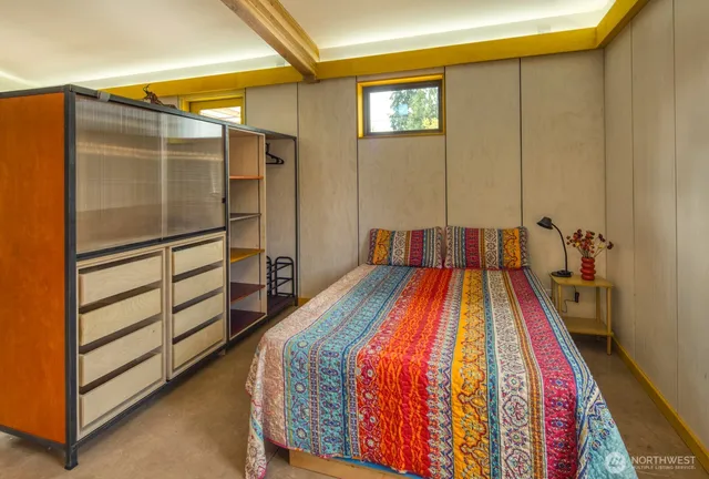 a bedroom with a bed and a dresser