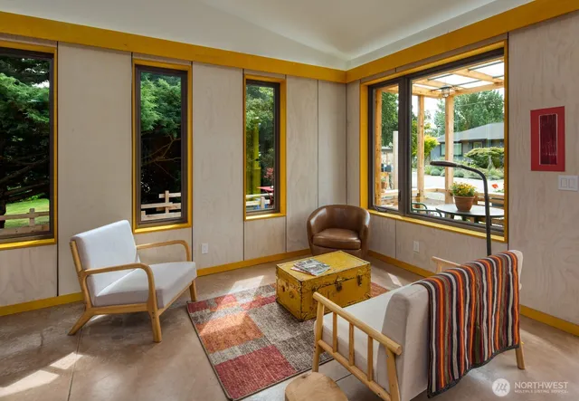 a bedroom with furniture and large windows