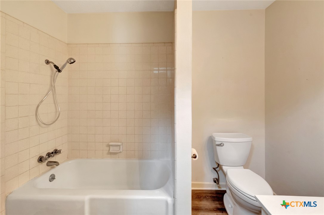 919 Eden Roc Street Victoria, TX 77904 - Photo 15 of 36 a white toilet sitting next to a bath tub