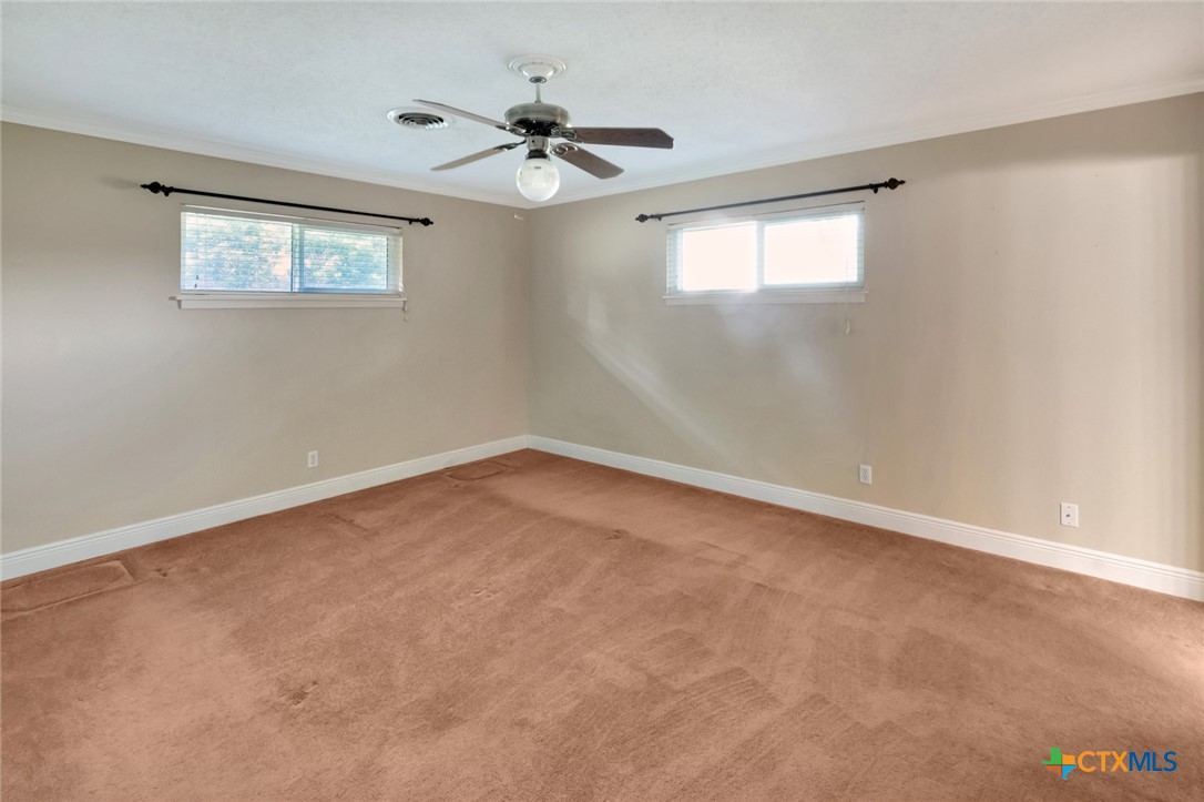 919 Eden Roc Street Victoria, TX 77904 - Photo 21 of 36 an empty room with windows and fan