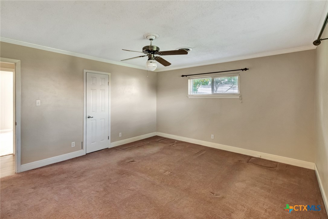 919 Eden Roc Street Victoria, TX 77904 - Photo 23 of 36 an empty room with windows and fan