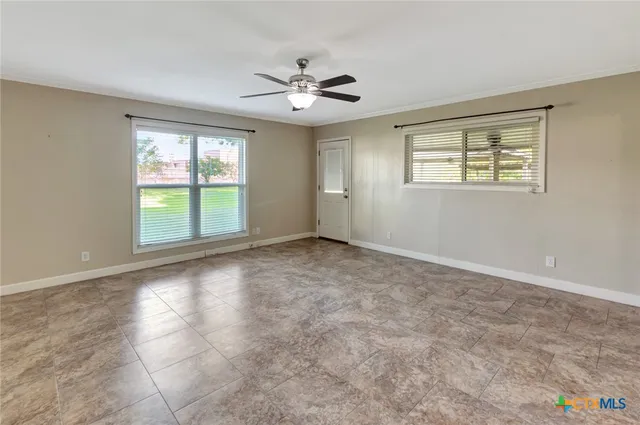 a view of an empty room with a window