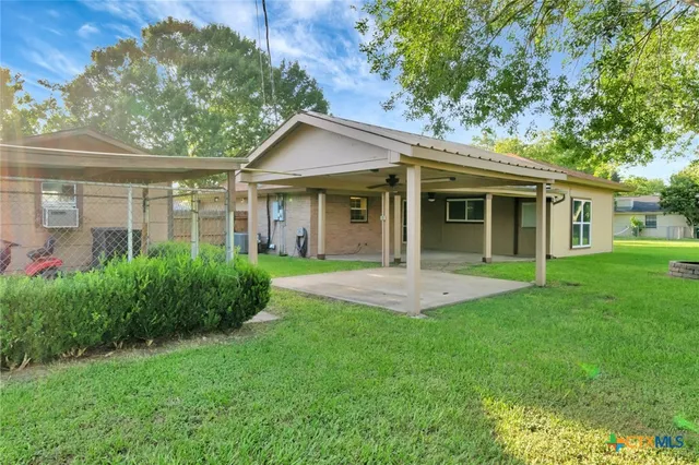 a view of a house with a yard and plants