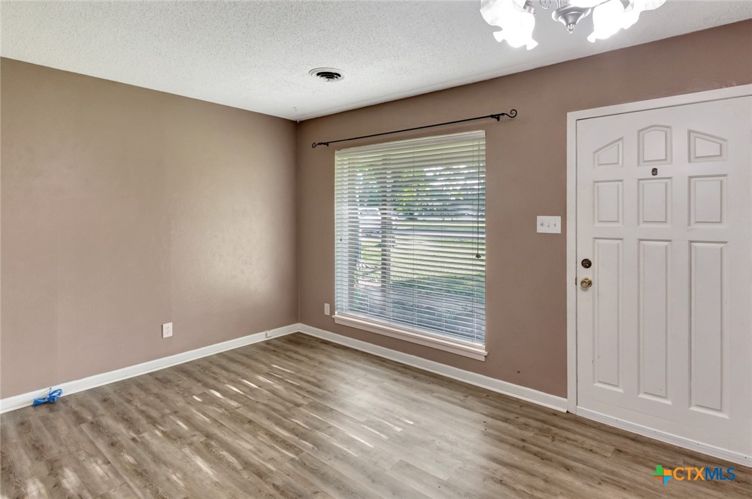 919 Eden Roc Street Victoria, TX 77904 - Photo 4 of 36 a view of an empty room with wooden floor and a window