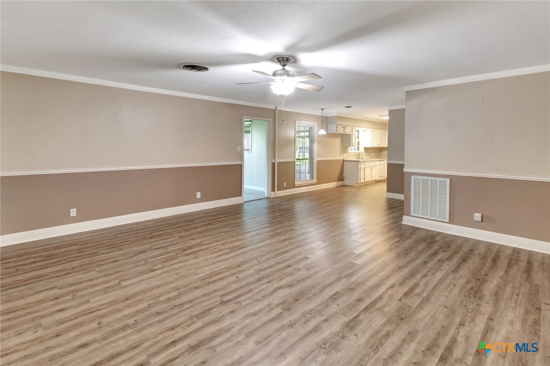 919 Eden Roc Street Victoria, TX 77904 - Photo 5 of 36 a view of an empty room with wooden floor and a window