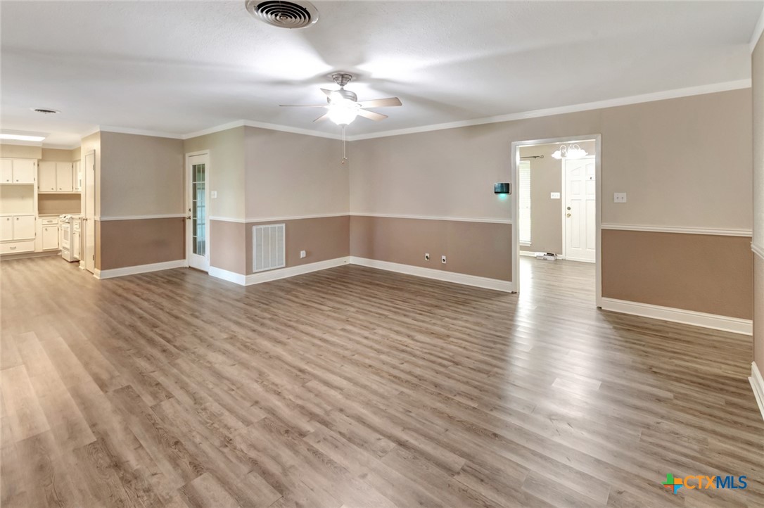 919 Eden Roc Street Victoria, TX 77904 - Photo 6 of 36 wooden floor in an empty room with a window