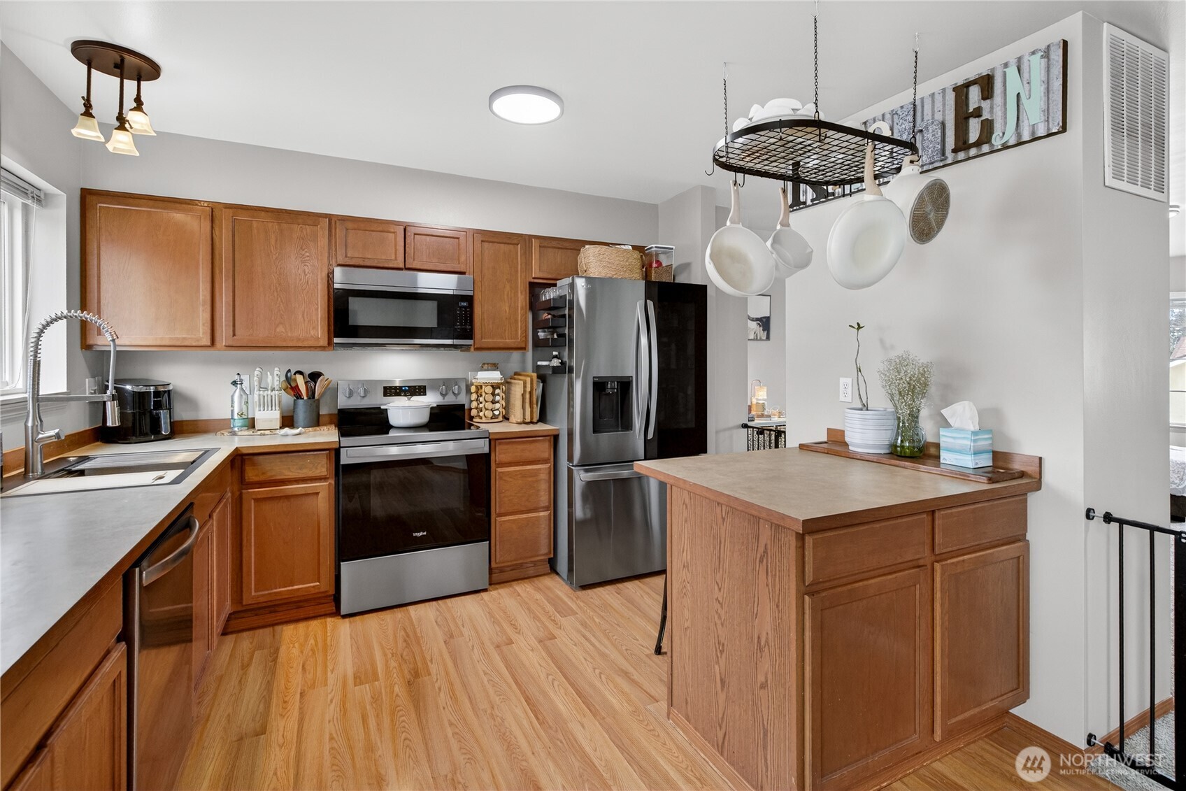 1506 Historic Lane Wenatchee, WA 98801 - Photo 5 of 28 a kitchen with stainless steel appliances a sink a stove a refrigerator cabinets and a window