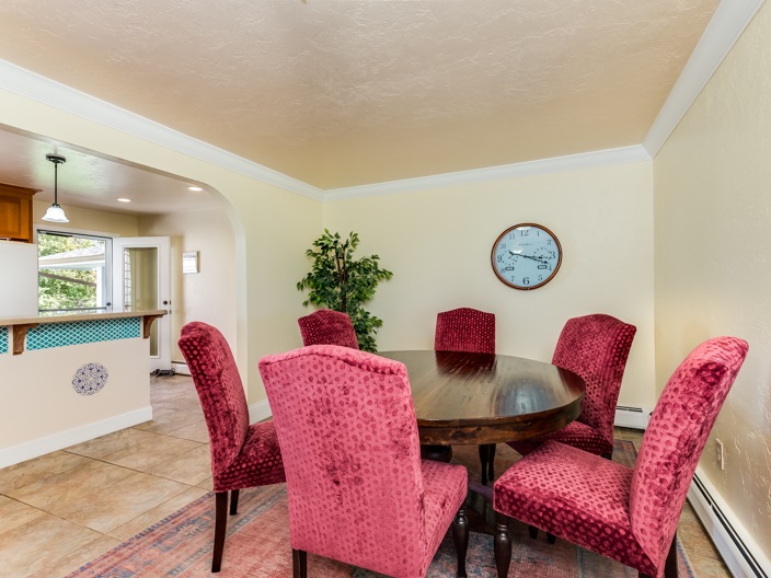1006 21 Road Grand Junction, CO 81505 - Photo 8 of 42 a dining room with furniture and a wooden floor