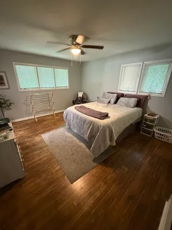 a bedroom with a large bed and a chandelier