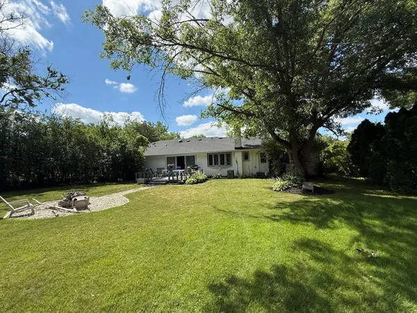 a view of a house with swimming pool and yard