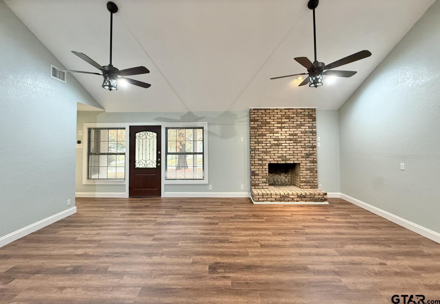 603 Wilma Street Tyler, TX 75701 - Photo 12 of 26 a view of an empty room with a fireplace and a window