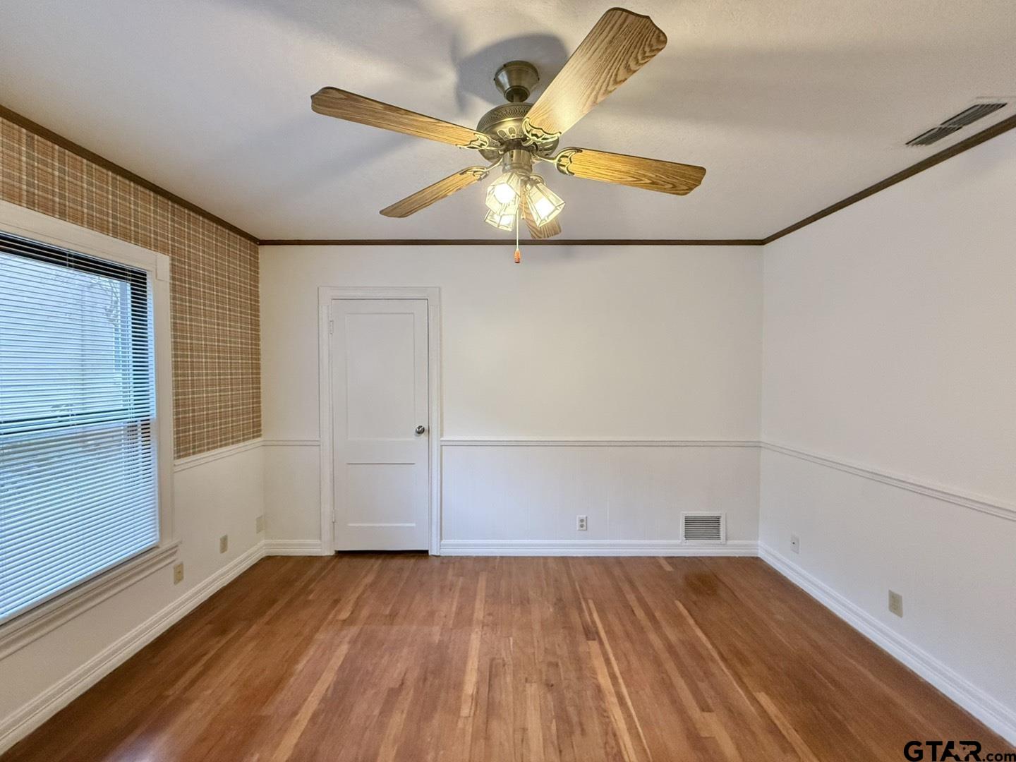 603 Wilma Street Tyler, TX 75701 - Photo 17 of 26 an empty room with wooden floor and windows