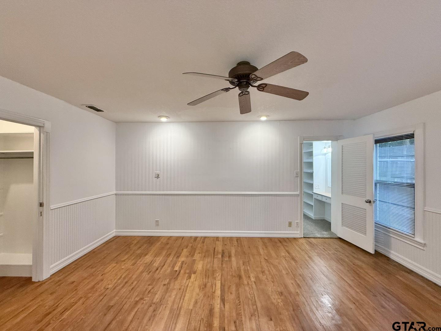 603 Wilma Street Tyler, TX 75701 - Photo 20 of 26 an empty room with wooden floor and windows