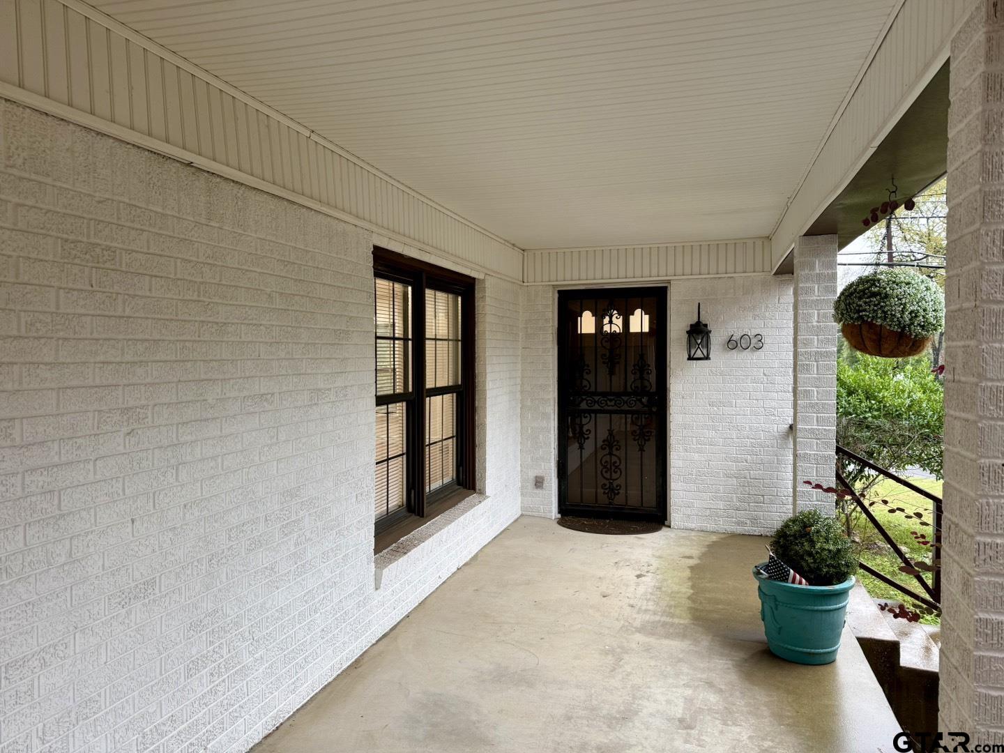 603 Wilma Street Tyler, TX 75701 - Photo 2 of 26 a view of a entryway door with potted plants