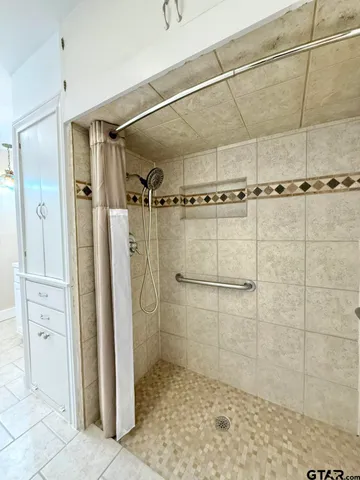 a spacious bathroom with a toilet sink and a mirror