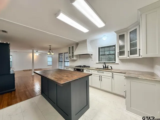 a kitchen with stainless steel appliances granite countertop hardwood a sink stove and refrigerator
