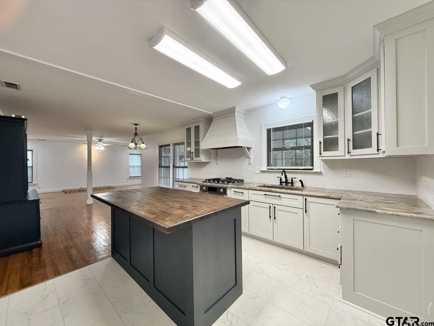 603 Wilma Street Tyler, TX 75701 - Photo 7 of 26 a kitchen with stainless steel appliances granite countertop hardwood a sink stove and refrigerator