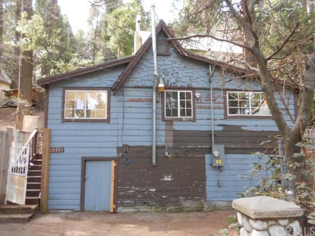23421 Kay Road Crestline, CA 92325 - Photo 1 of 1 a front view of a house with a yard