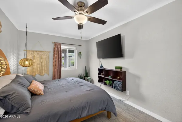 a bedroom with a bed couch and window