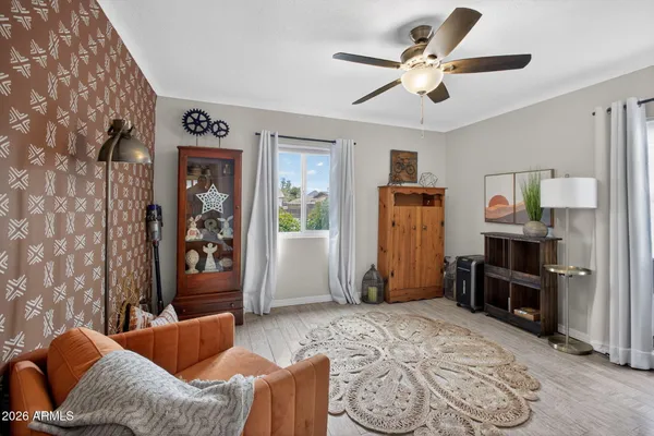 a bedroom with a bed and a flat screen tv on dresser