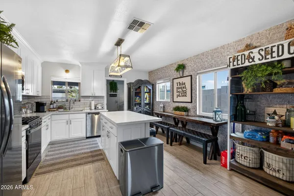 a large white kitchen with a large window