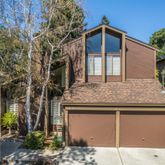 a front view of a house with plants