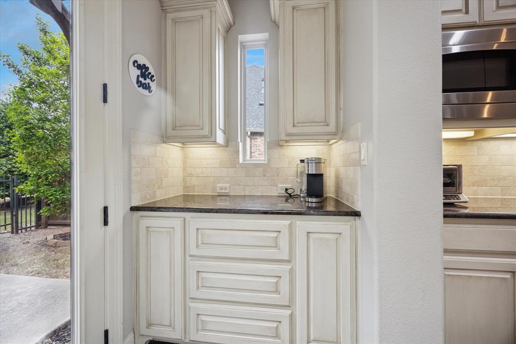 580 Butchart Drive Prosper, TX 75078 - Photo 11 of 40 Bar area featuring stainless steel microwave and tasteful backsplash