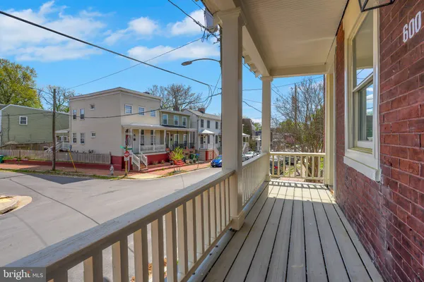 a view of a balcony with wooden floor