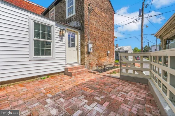 a backyard of a house with barbeque oven table and chairs