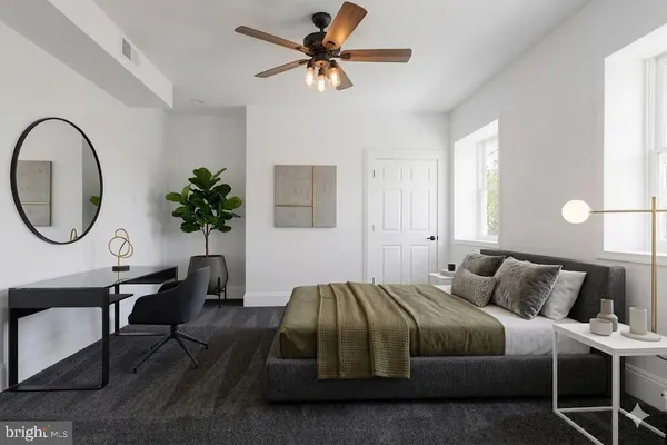 a bedroom with a bed a table and chair